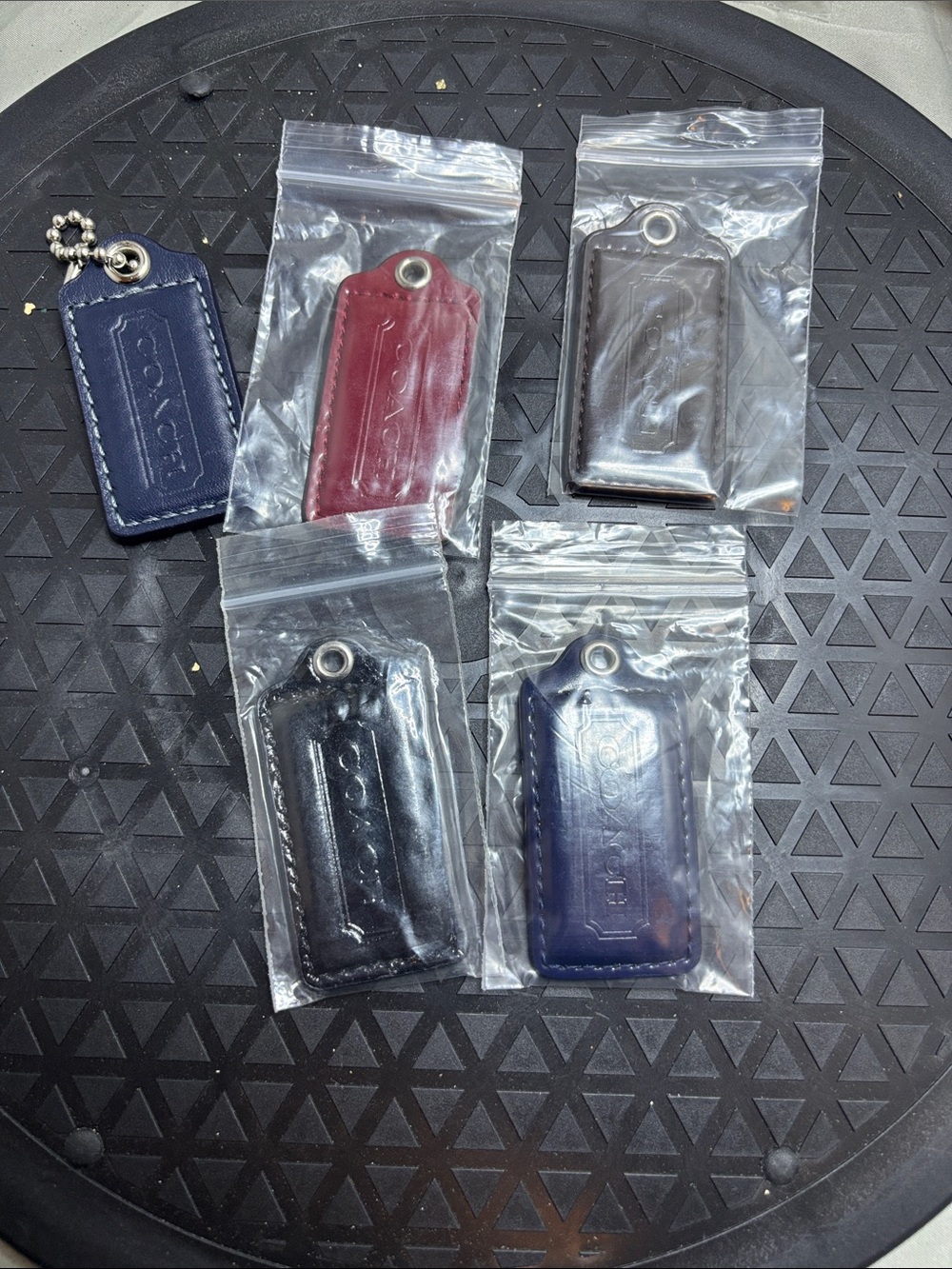 Coach Leather Key Tags in Navy, Red, Brown, and Black